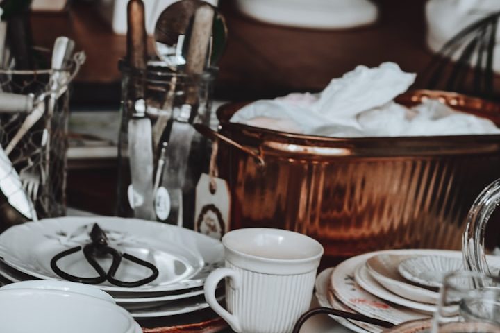 Home Organisation Service in Milton Keynes A table full of crockery and utensils needing home organisation by Kals Kleans in Milton Keynes